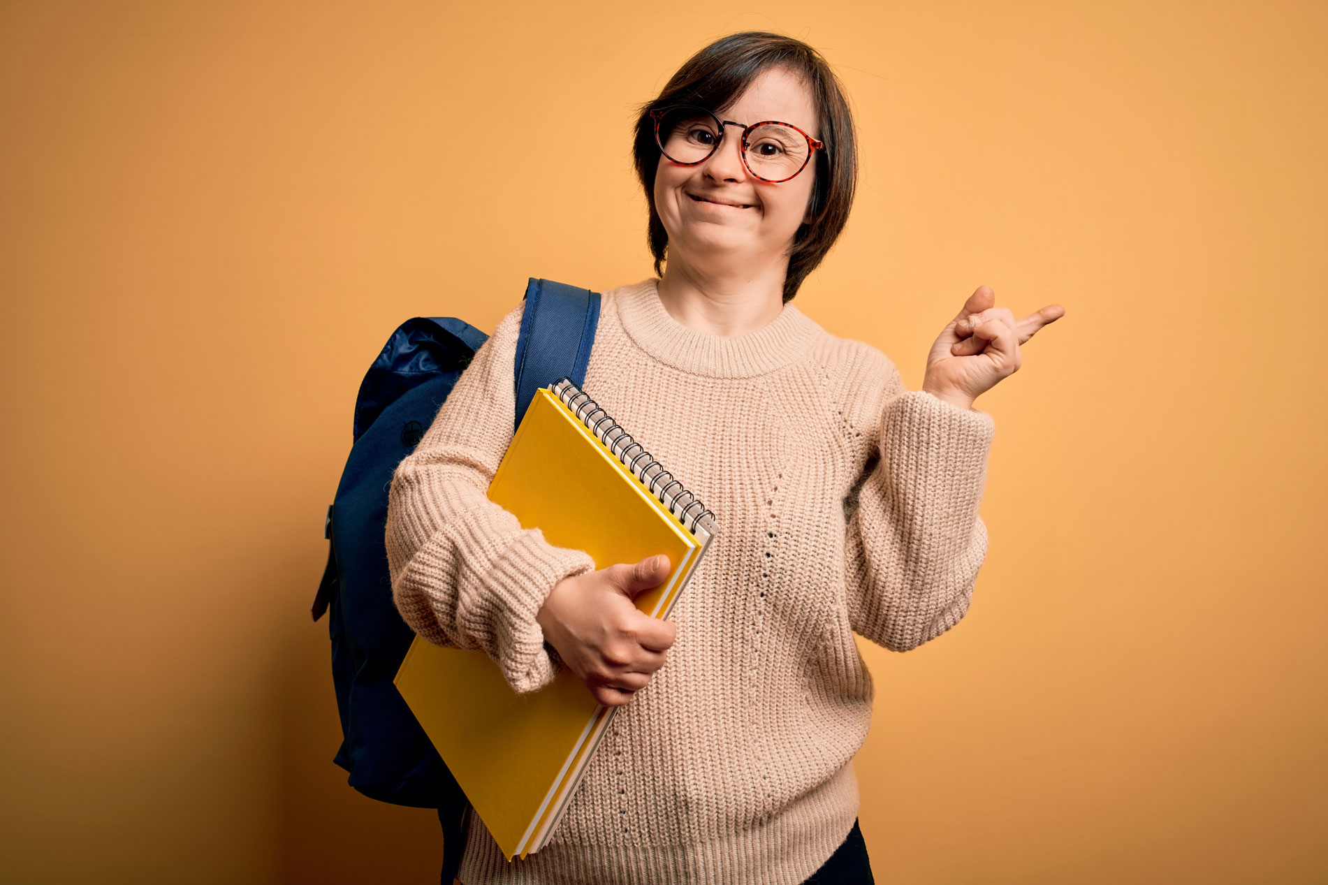 Young woman holds back pack